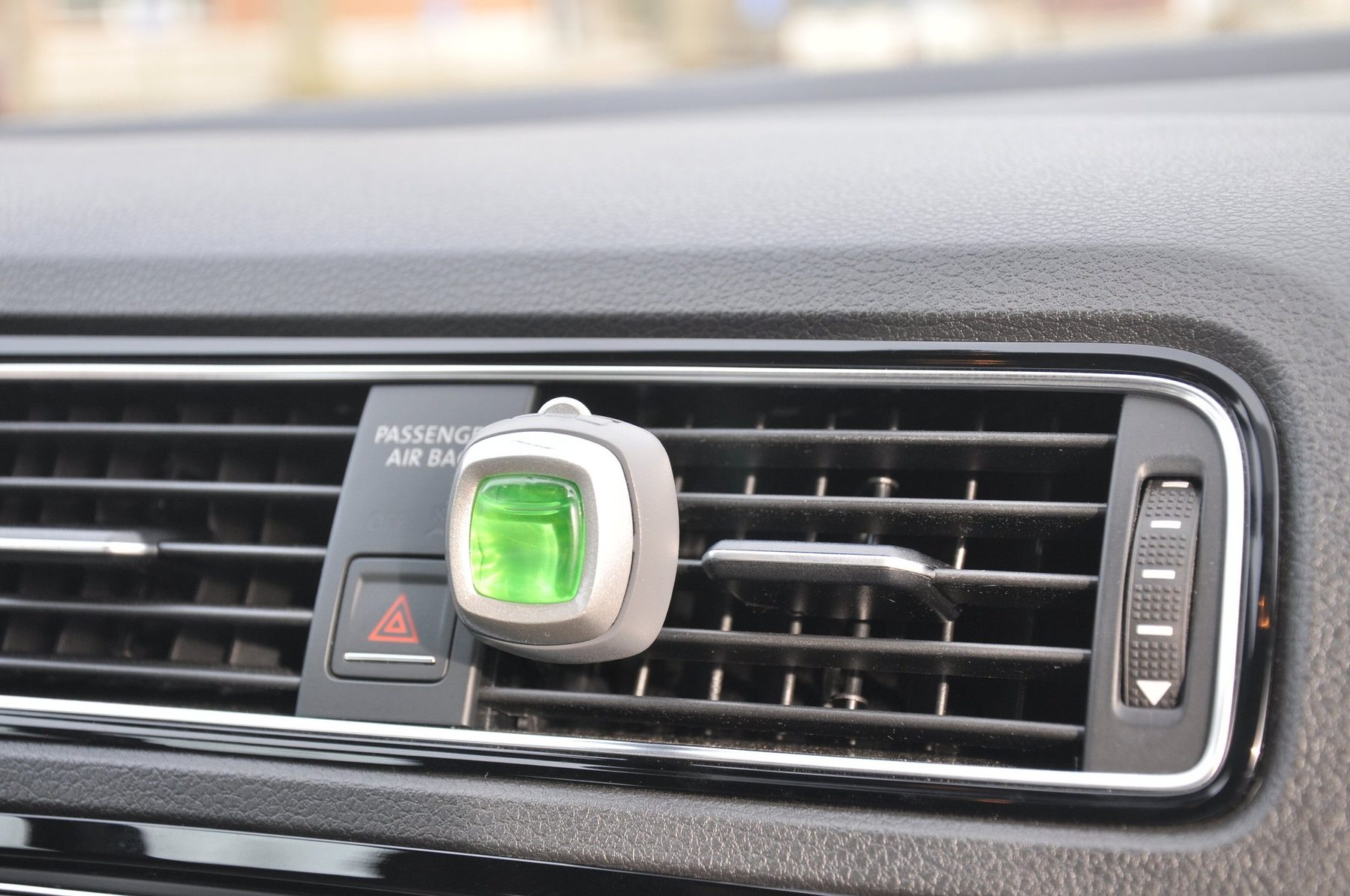 Car vent clip air freshener mounted in a vehicle vent — detail